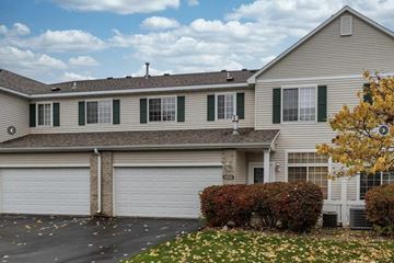 Rochester apartment for rent - a white house with green shutters and a garage door
