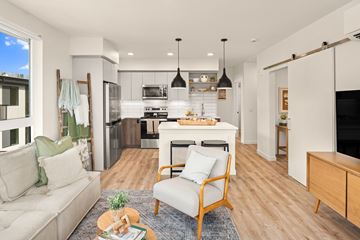Kirkland apartment for rent - A modern living room with a white sofa and a wooden chair.