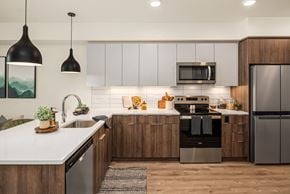 Kirkland apartment for rent - A modern kitchen with wooden cabinets and stainless steel appliances.