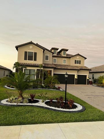 Estero house for rent - a house with a driveway and landscaping in front of it