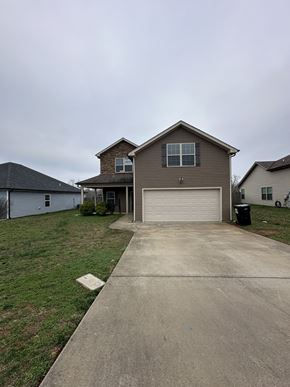 Clarksville house for rent - a driveway in front of a house with a garage door