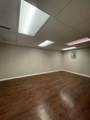 Clarksville house for rent - A room with wooden floors and a ceiling with lights.