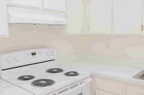 Cypress apartment for rent - A white stove with four burners is in a kitchen.