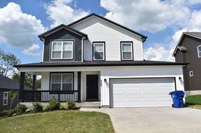 Clarksville house for rent - A two-story house with a black door and white garage door.