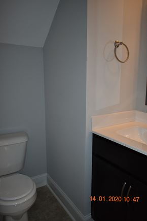 Clarksville house for rent - A bathroom with a toilet and a sink.