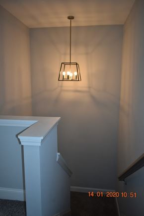 Clarksville house for rent - A light fixture hangs over a staircase.