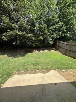 Clarksville house for rent - a yard with a fence and grass and trees