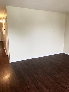 Clarksville house for rent - A room with wooden flooring and white walls.