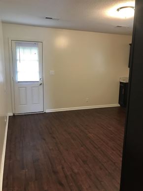 Clarksville house for rent - A room with a white door and wooden flooring.