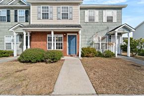 Jacksonville house for rent - a sidewalk in front of a house with a blue door