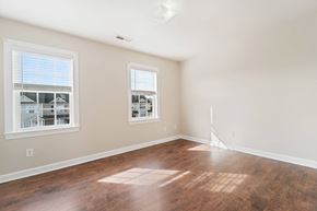 Jacksonville house for rent - a living room with a hard wood floor and two windows