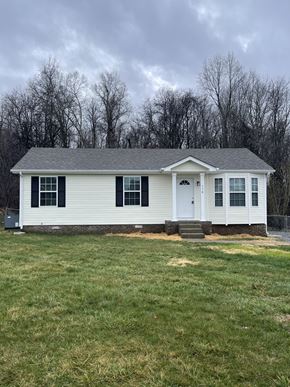Oak Grove house for rent - a white house with a grassy yard and trees in the background