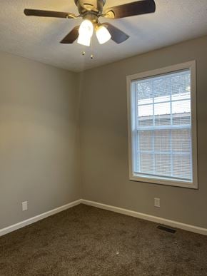 Oak Grove house for rent - an empty bedroom with a ceiling fan and a window