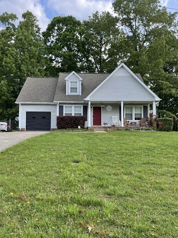 Clarksville house for rent - A house with a red door and a grey roof.