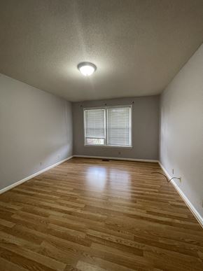 Clarksville house for rent - A room with wooden flooring and a window with blinds.