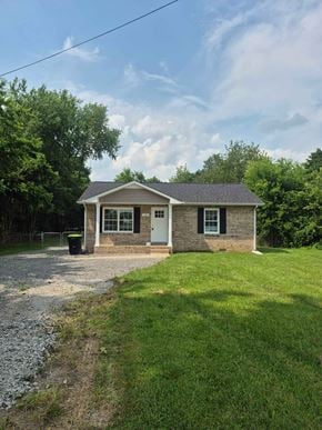 Oak Grove house for rent - A small house with a gravel driveway in front.