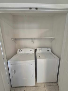 Oak Grove house for rent - Two white front loading washing machines in a small laundry room.
