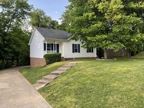 Clarksville house for rent - A white house with a green lawn in front.