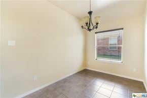 Copperas Cove house for rent - an empty room with a window and a chandelier