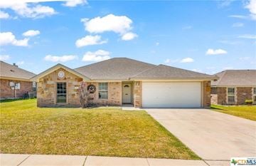 Copperas Cove house for rent - a brick house with a garage and a lawn