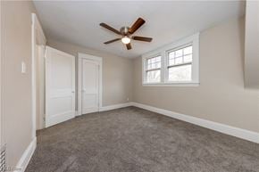 Maple Heights house for rent - an empty living room with a ceiling fan and a window