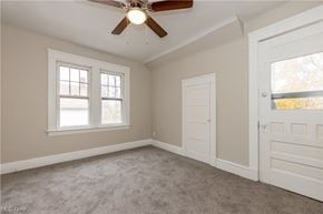 Maple Heights house for rent - an empty bedroom with a ceiling fan and two windows