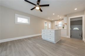 Maple Heights house for rent - an open kitchen and living room with a ceiling fan