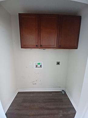 Clarksville house for rent - A room with brown cabinets and a brown carpet.