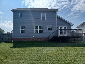 Clarksville house for rent - A house with a grey exterior and a deck.