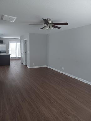 Clarksville house for rent - A room with a ceiling fan and wood flooring.