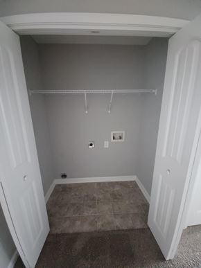 Clarksville house for rent - A white closet with a shelf and a carpeted floor.