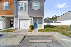 Jacksonville house for rent - A two-story house with a garage and a driveway in front.