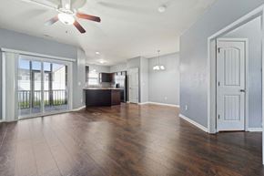 Jacksonville house for rent - A spacious room with a ceiling fan and wooden flooring.