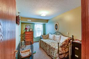 Tiffin apartment for rent - a bedroom with a bed and a crib and a dresser