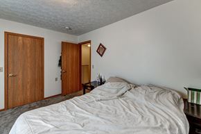 Newark apartment for rent - a bedroom with an unmade bed and a door to a bathroom