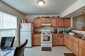Newark apartment for rent - a kitchen with white appliances and wooden cabinets