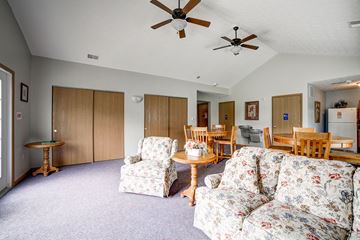 Indiana apartment for rent - a living room with couches and chairs and a dining room table