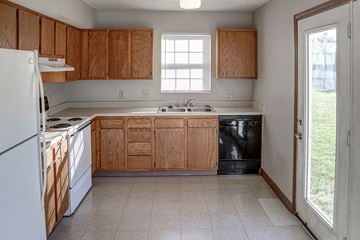 Washington Court House apartment for rent - a kitchen with wooden cabinets and white appliances