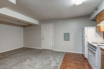 Dennison apartment for rent - a kitchen with a refrigerator and a stove and a door