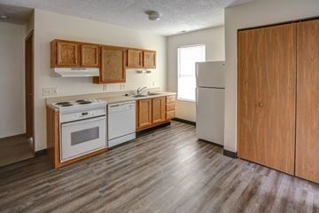 Clyde apartment for rent - an empty kitchen with wood flooring and white appliances