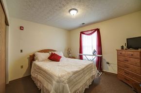 Slippery Rock apartment for rent - a bedroom with a bed and a dresser and a window