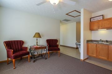 Orrville apartment for rent - a living room with two chairs and a table with a lamp