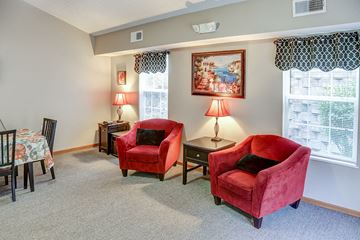 Prestonsburg apartment for rent - a living room with two red chairs and a table