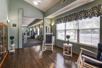 Wheeling apartment for rent - a living room with chairs and a large window