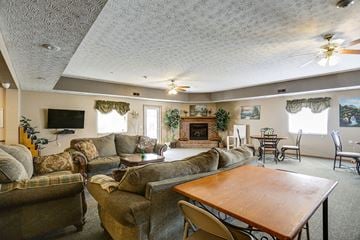 Fostoria apartment for rent - a living room with couches and a table and a fireplace