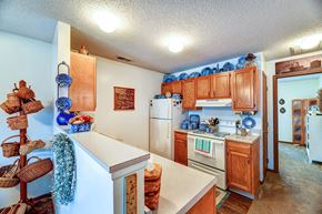 Barnesville apartment for rent - a kitchen with white appliances and wooden cabinets