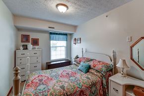 Barnesville apartment for rent - a bedroom with a bed and a dresser and a window