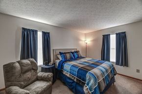 Zanesville apartment for rent - a bedroom with a bed and a chair