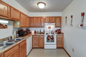 Crestline apartment for rent - a kitchen with white appliances and wooden cabinets