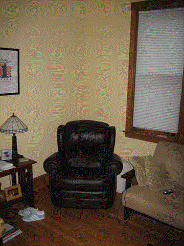 Chicago apartment for rent - a leather chair in a living room next to a window